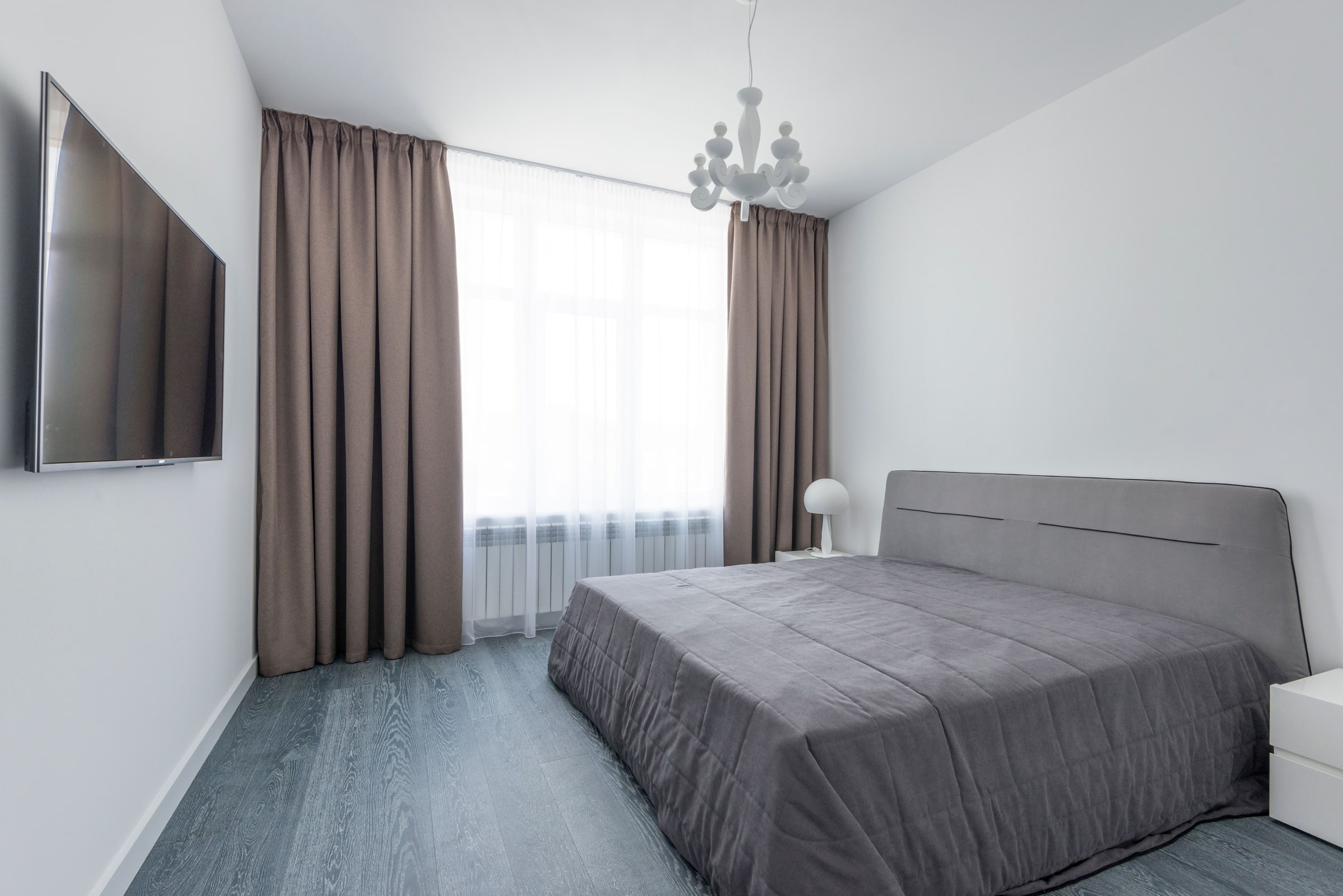 Floor-length curtains in a bright bedroom