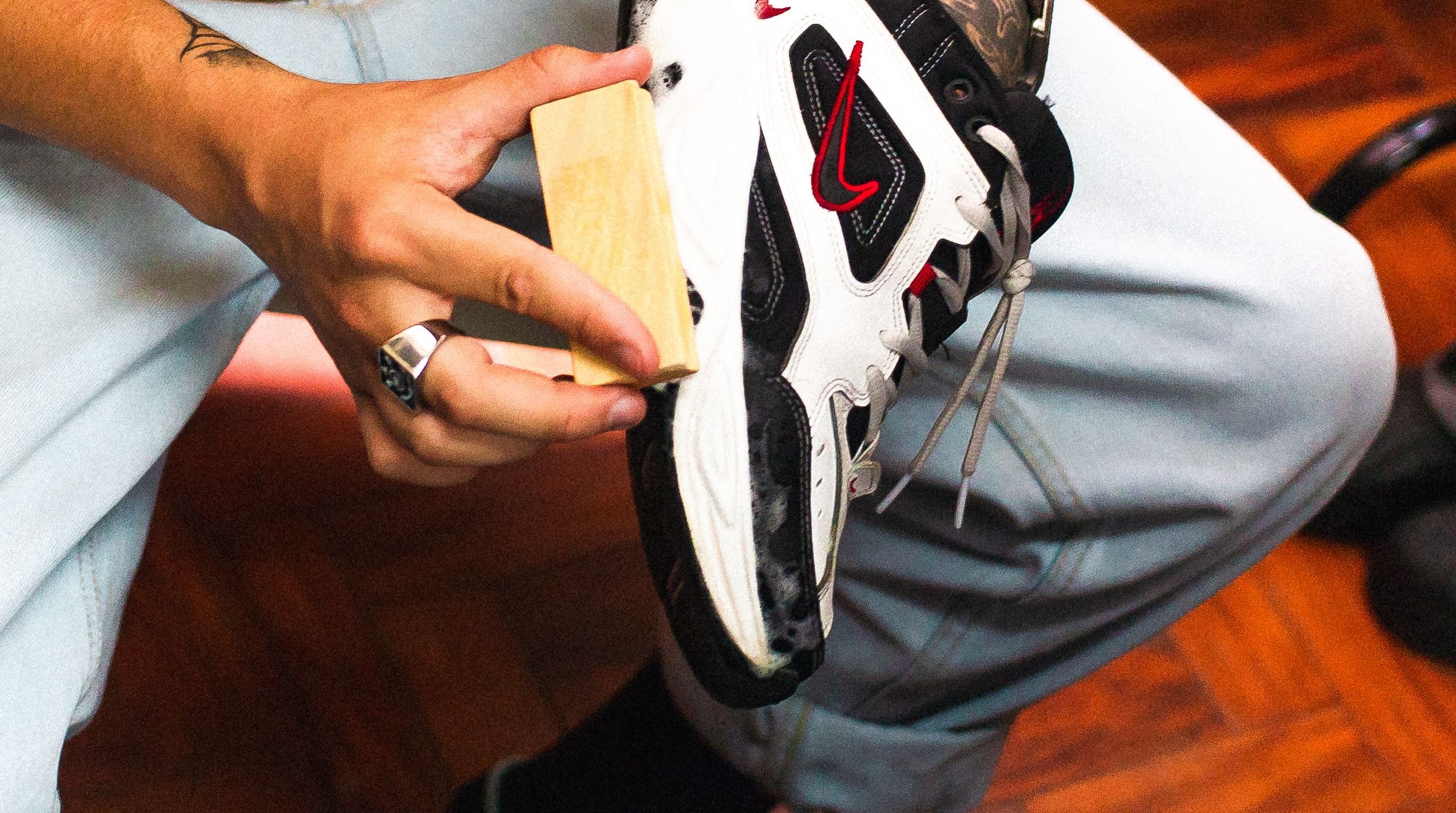 Hands brushing a sneaker clean